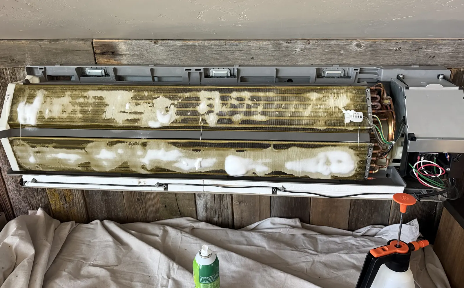 Foam cleaner applied to a mini split indoor coil during a maintenance visit
