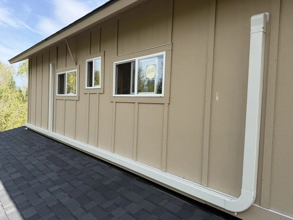 White mini split line-set cover running down the siding and along the wall
